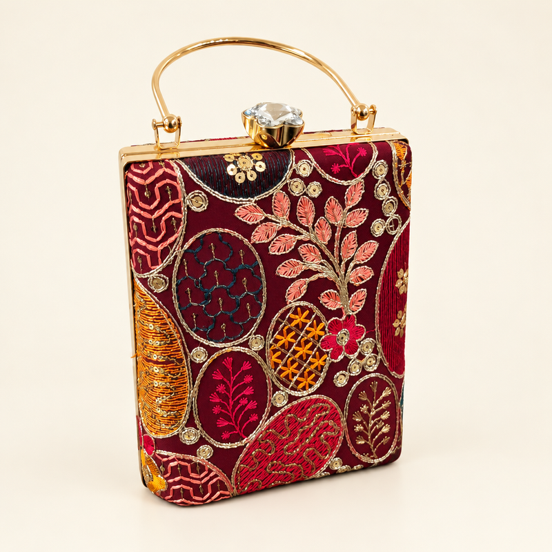 Burgundy embroidered upright box bag with gold-tone top handle and crystal-look clasp