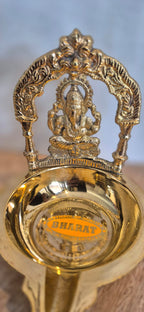 Ganesha diya brass oil lamp front view close-up
