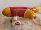 Channapatna wooden toy aeroplane front-side view showing red fuselage and yellow wingtips