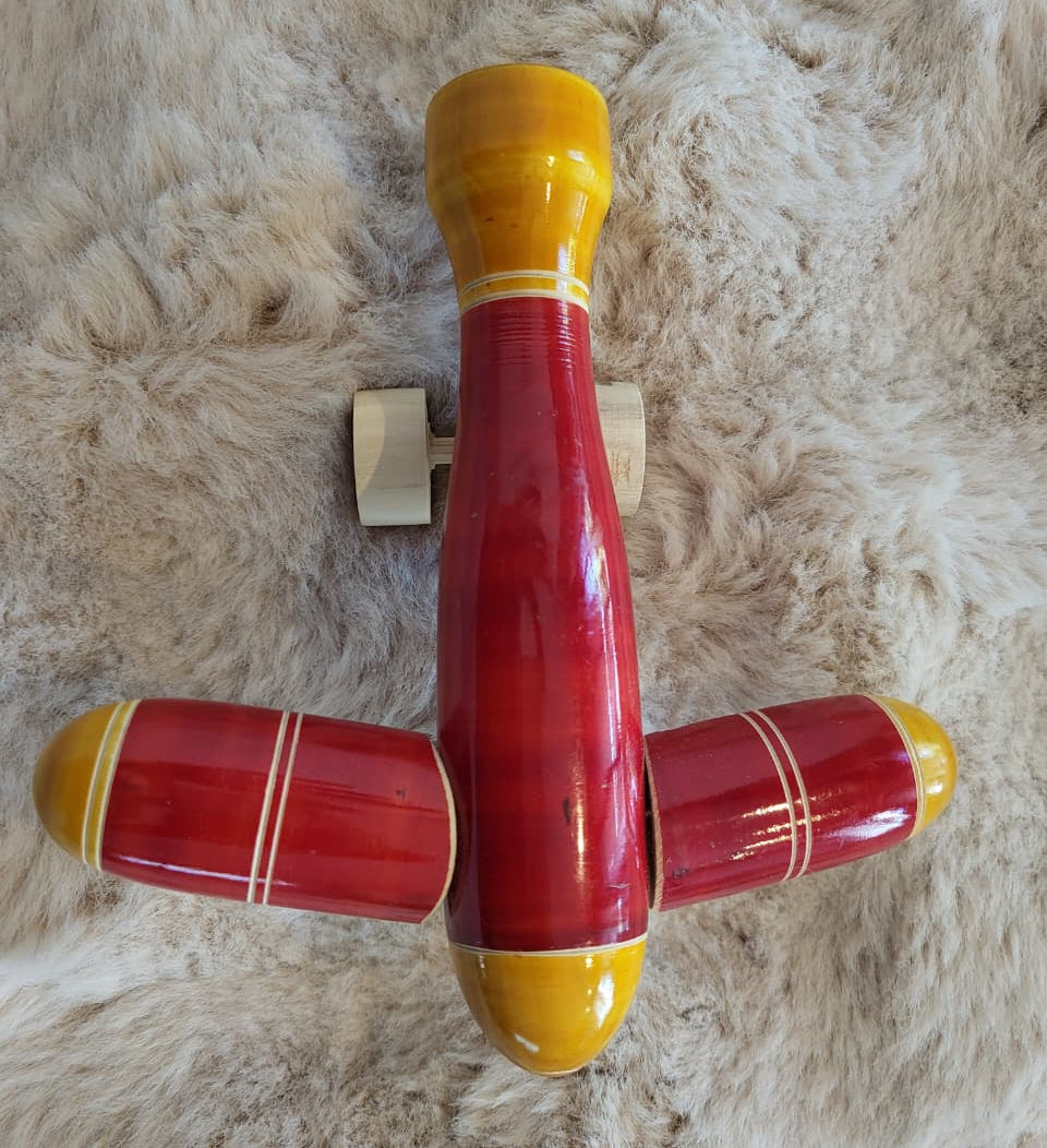 Channapatna wooden toy aeroplane overhead flat lay view