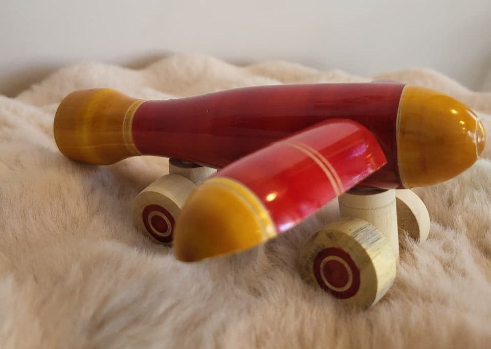 Channapatna wooden toy aeroplane rear view on fur rug