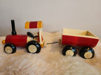 Wooden toy tractor and trailer side view on fur rug