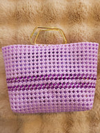 Handwoven lavender basket bag top-down view on fur rug