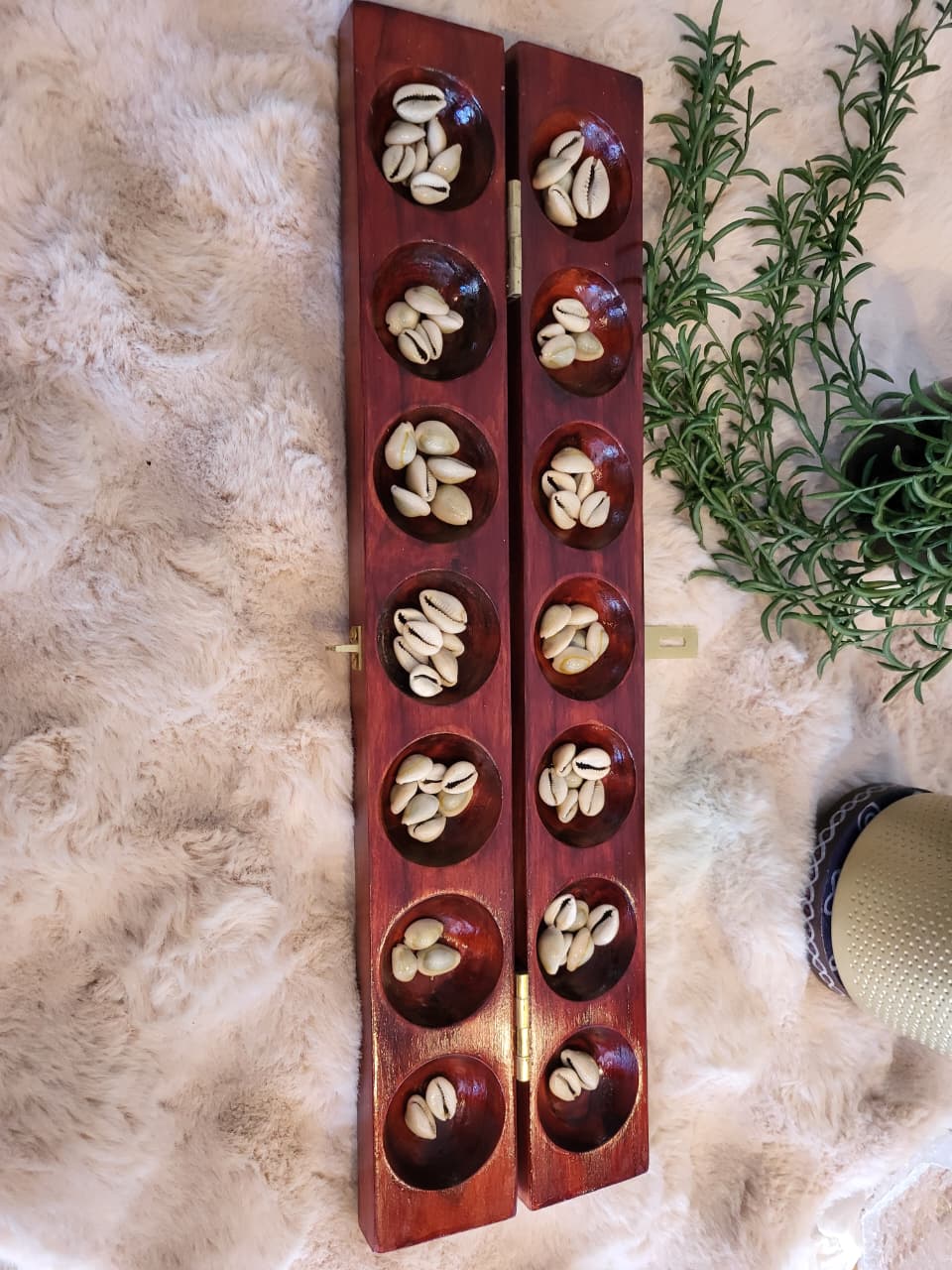 Pallanguzhi large board open top-down view with cowrie shells in pits