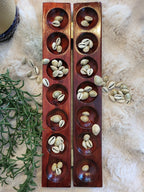 Mancala board closed showing wood grain and brass latch