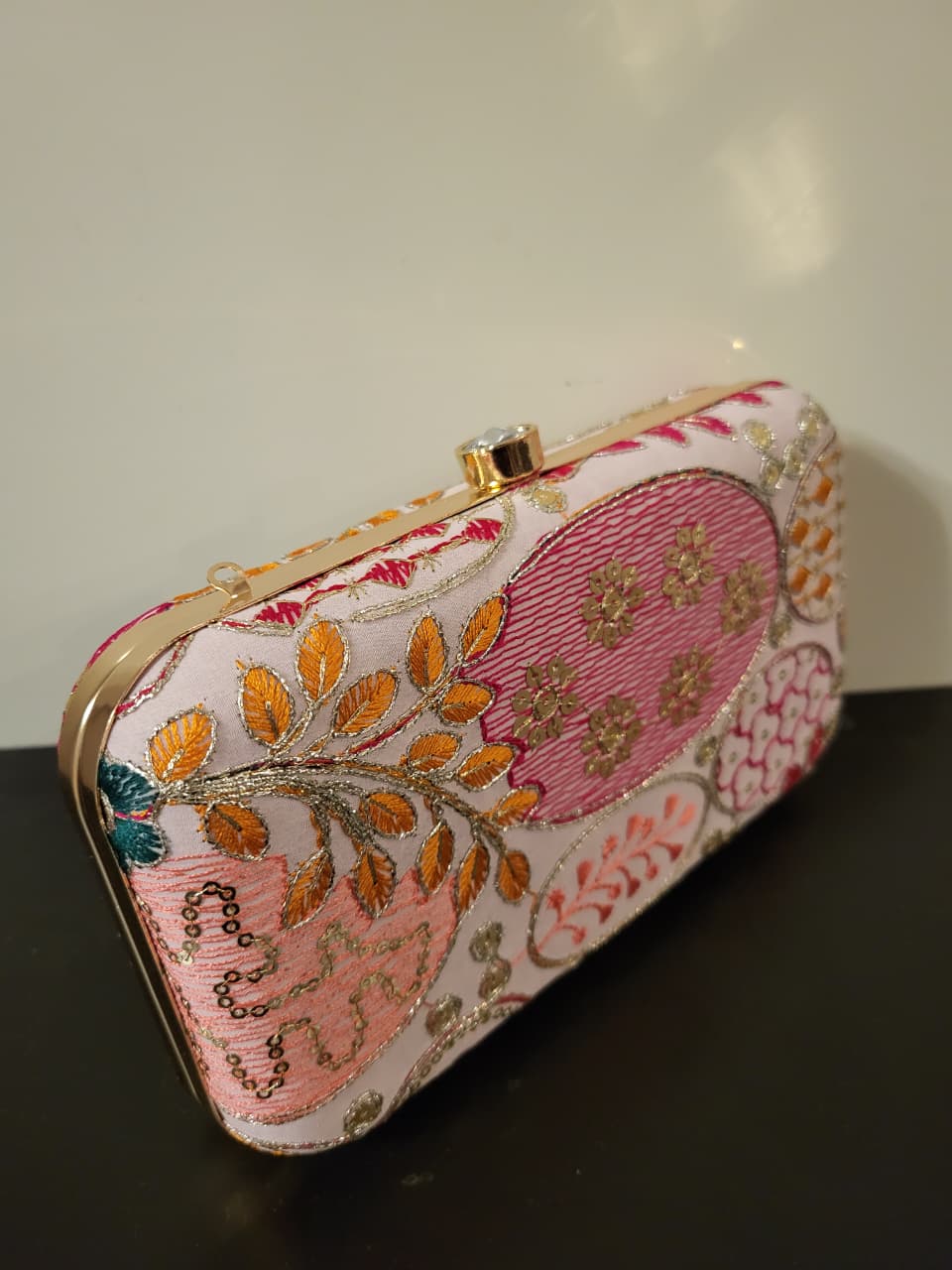 Original light and pink ornamental clutch, side view