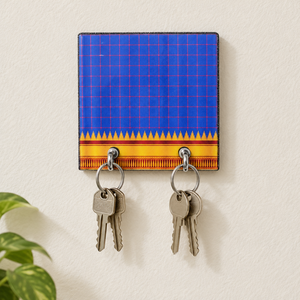 Compact blue key holder with keys on a wall