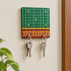 Compact green key holder with keys on a wall