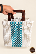 Hand-held front view of white-teal stripe handwoven handbag with wooden handles