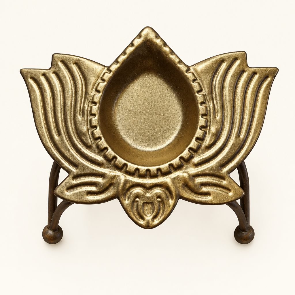 Top view of brass-coated decorative diya bowl on ivory background