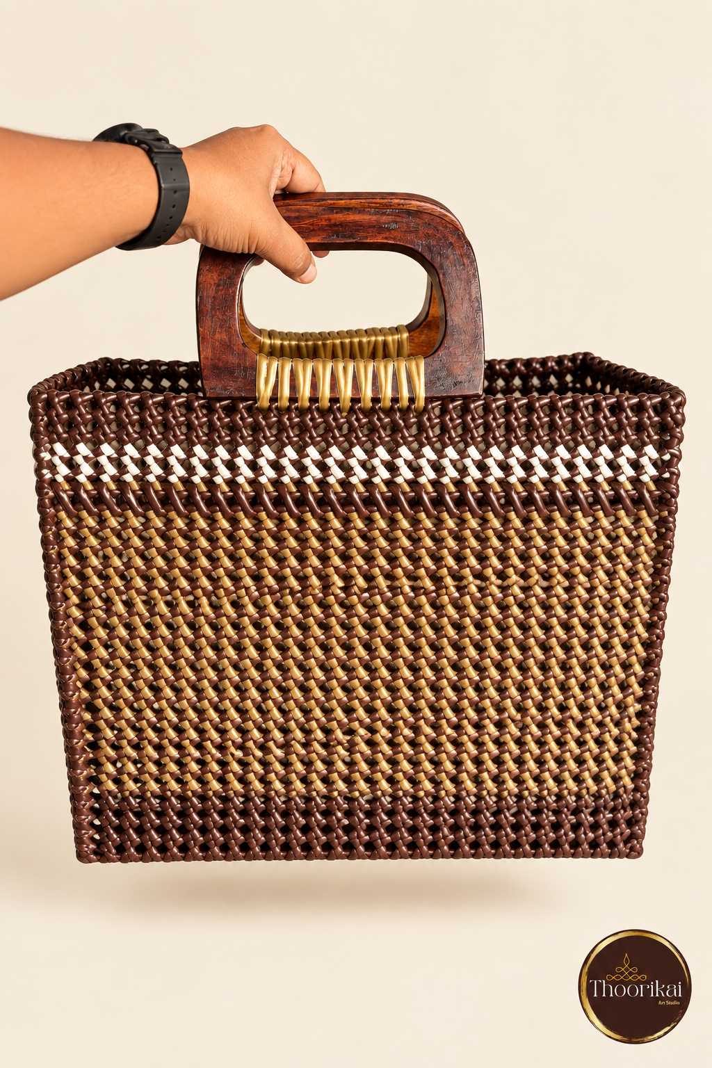 Front view of brown-gold handwoven market bag with wooden handles and white accent band