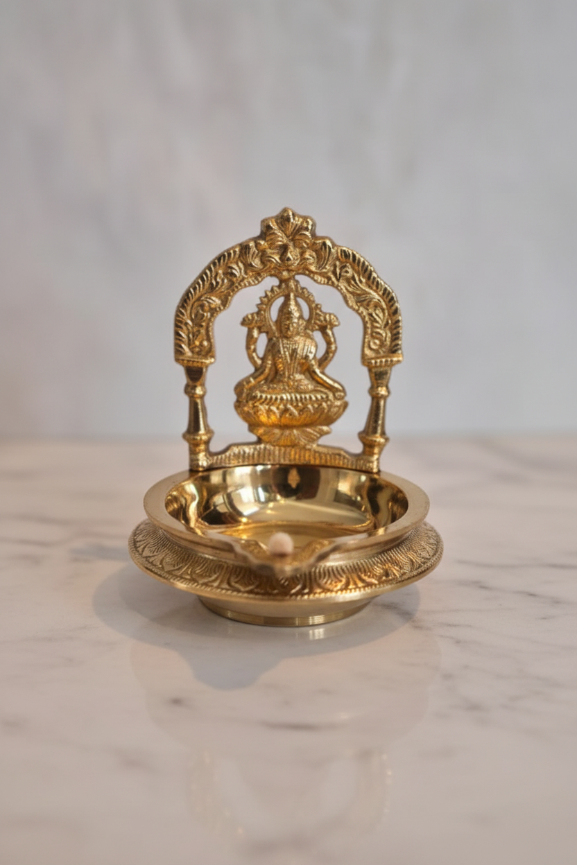 Lakshmi diya on white marble with temple-inspired lighting