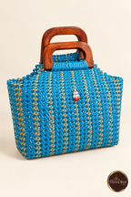 Slightly elevated view of peacock blue-gold handwoven handbag