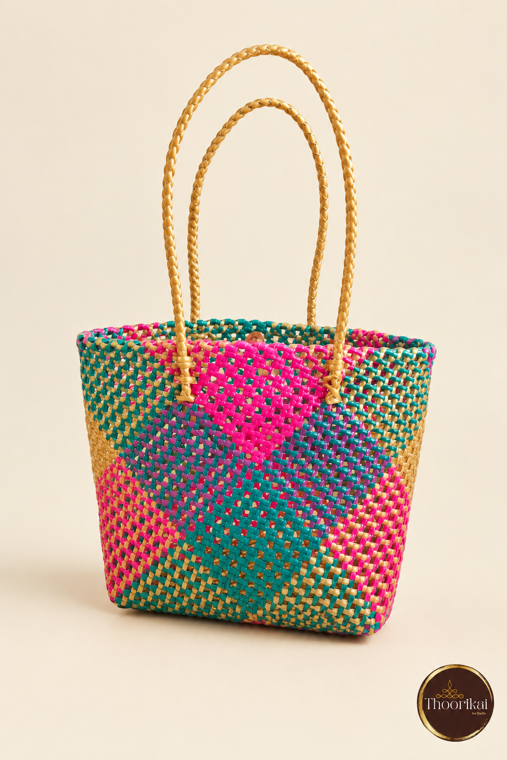 Angled front view of pink-green-gold handwoven tote bag