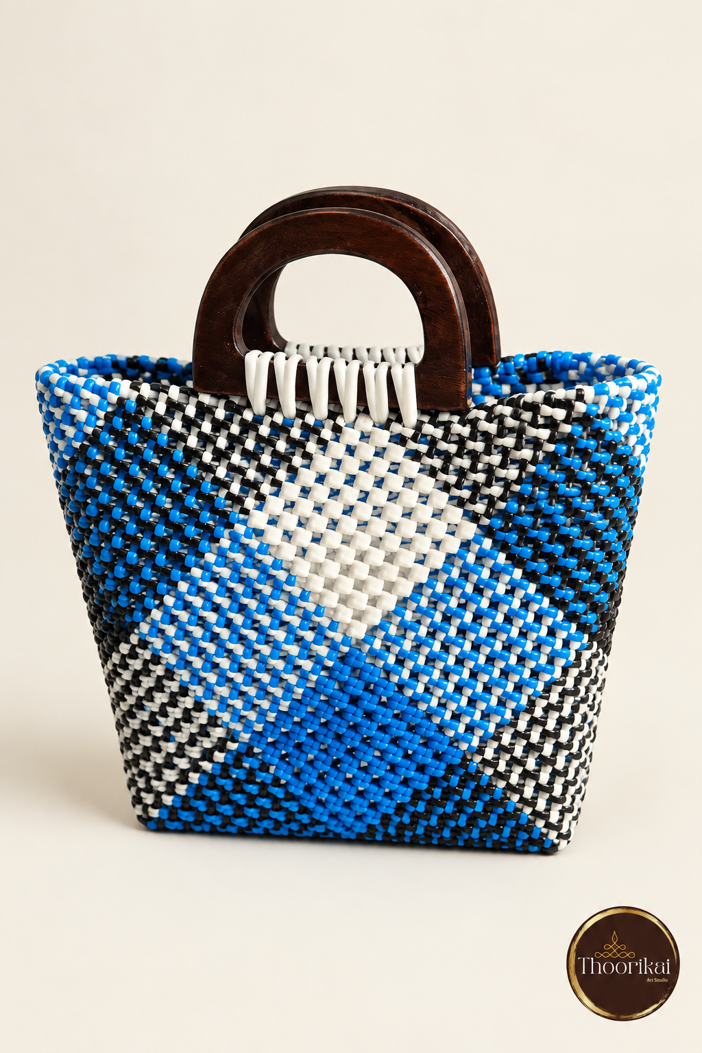 Slightly elevated view of blue-black-white woven small handbag