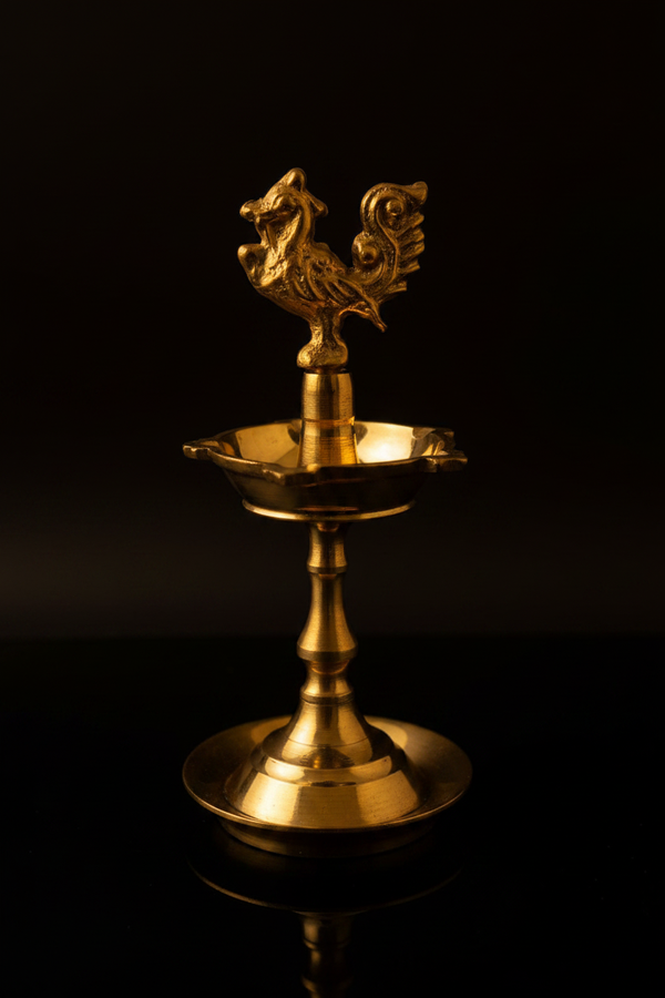 Mayil Vilakku brass peacock diya on black background
