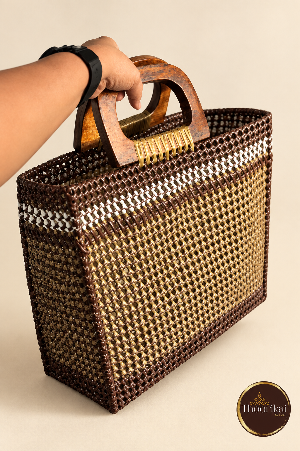 Hand-held angled side view of brown-gold market bag