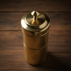 Overhead view of brass filter coffee maker on dark wood