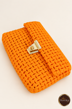 Diagonal flat view of orange woven clutch