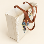 White floral beaded tote bag with fringe and brown handles
