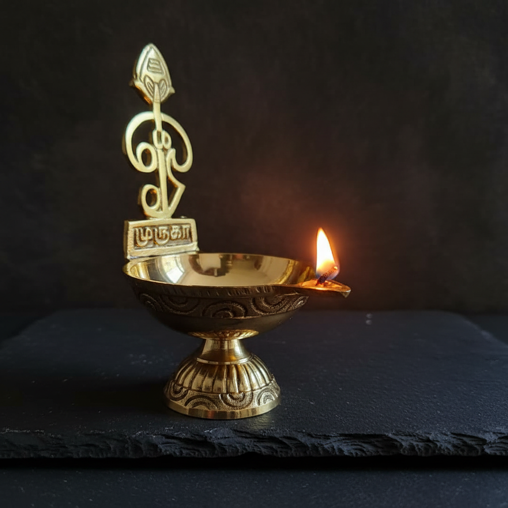 Brass Murugan Diya – moody dark background with candlelight
