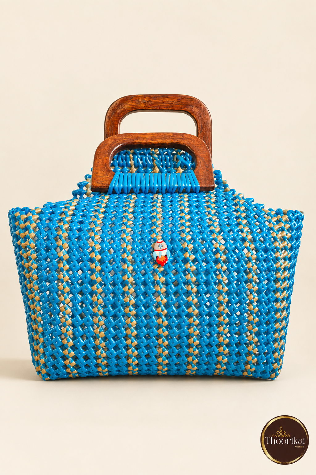 Front view of peacock blue-gold handwoven handbag with wooden handles