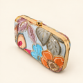 Light box clutch with large multicoloured floral embroidery, angled view