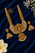 Antique Lakshmi necklace set with American Diamond and Kemp stones on dark blue fabric, with Thoorikai logo