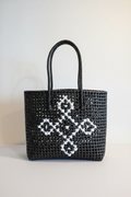 Black woven tote bag front view styled product photo
