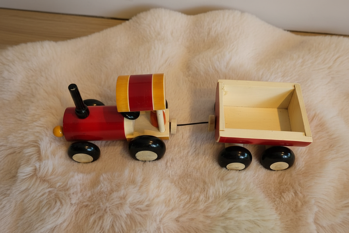 Wooden toy tractor and trailer flat lay lifestyle photo