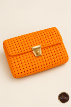Elevated view of orange clutch showing flap weave and clasp