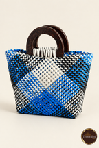 Three-quarter view of small blue diamond handwoven handbag