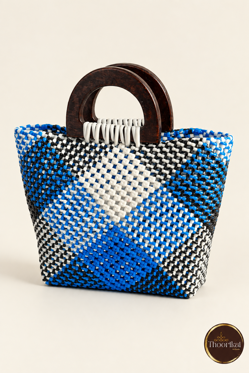 Three-quarter view of small blue diamond handwoven handbag