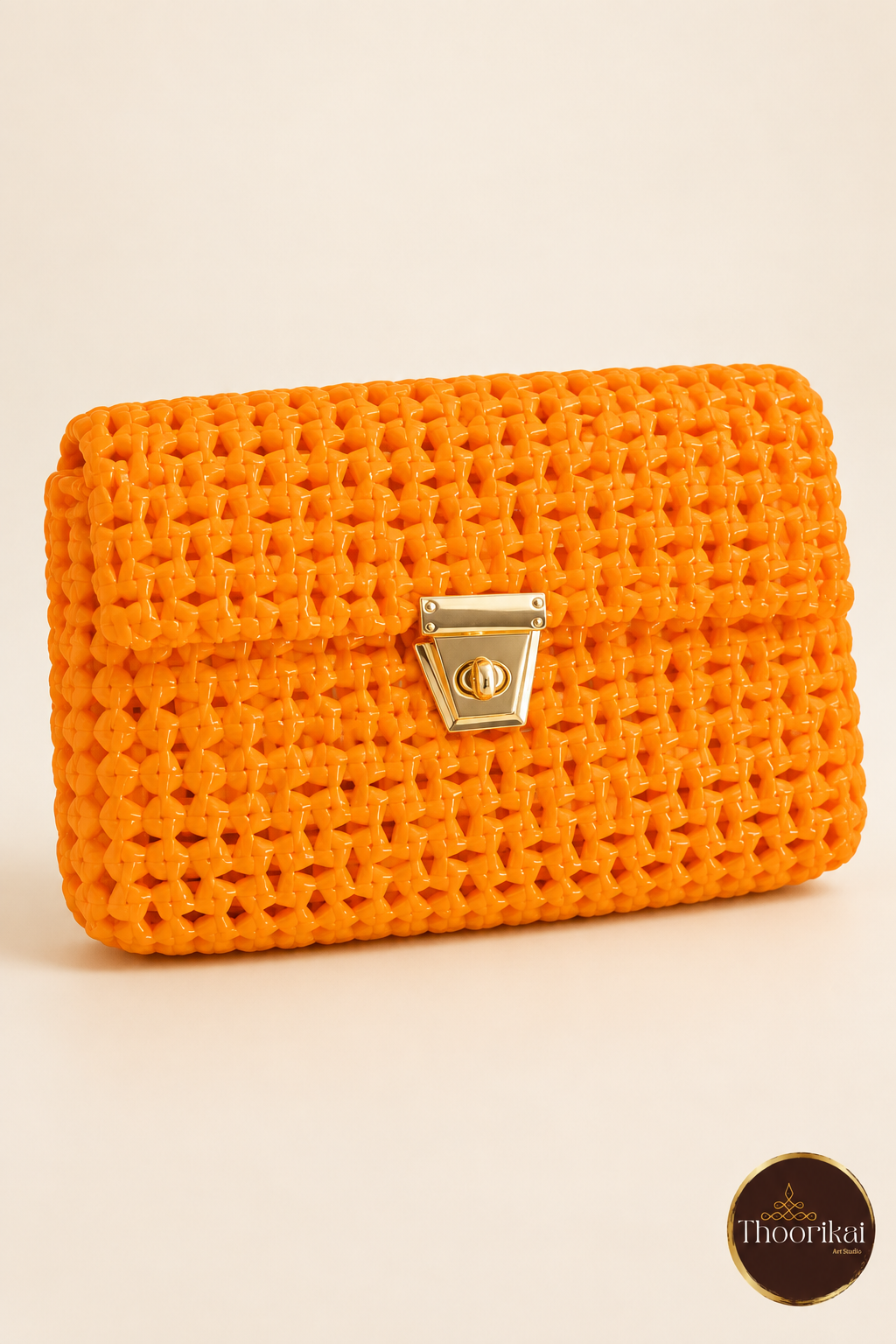 Angled front perspective of orange handwoven clutch