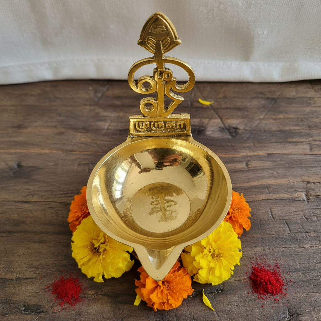 Brass Murugan Diya – overhead view with marigolds and kumkum